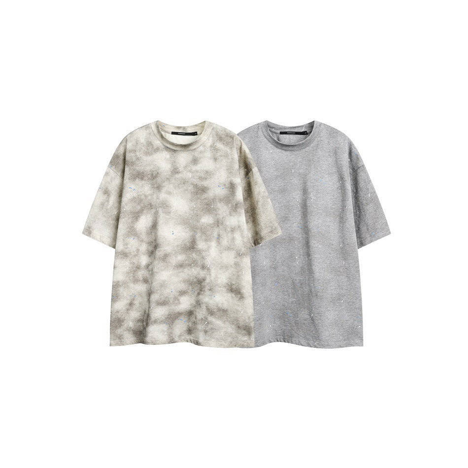 Two short-sleeve crew-neck T-shirts shown side by side: beige-gray mottled and heather gray, both with scattered flecks.
