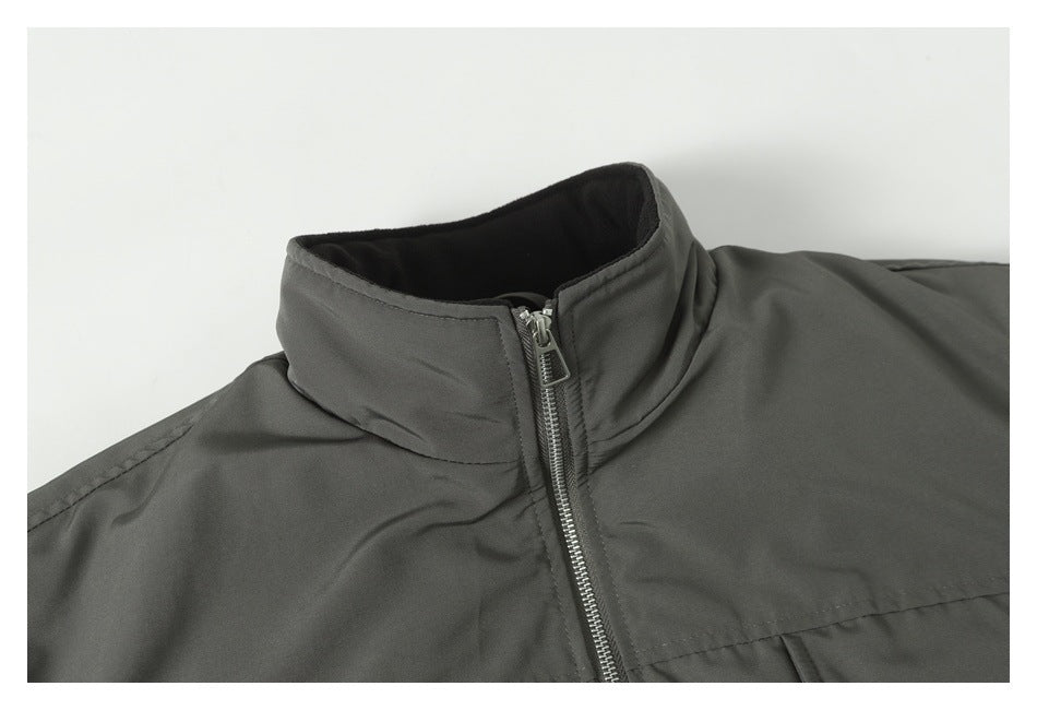 Close-up of a dark gray jacket's stand collar and front zipper.