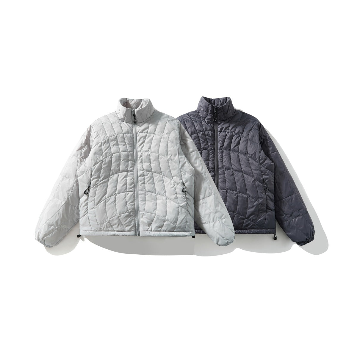 Two quilted stand-collar jackets shown from the front, one light gray and one dark charcoal.