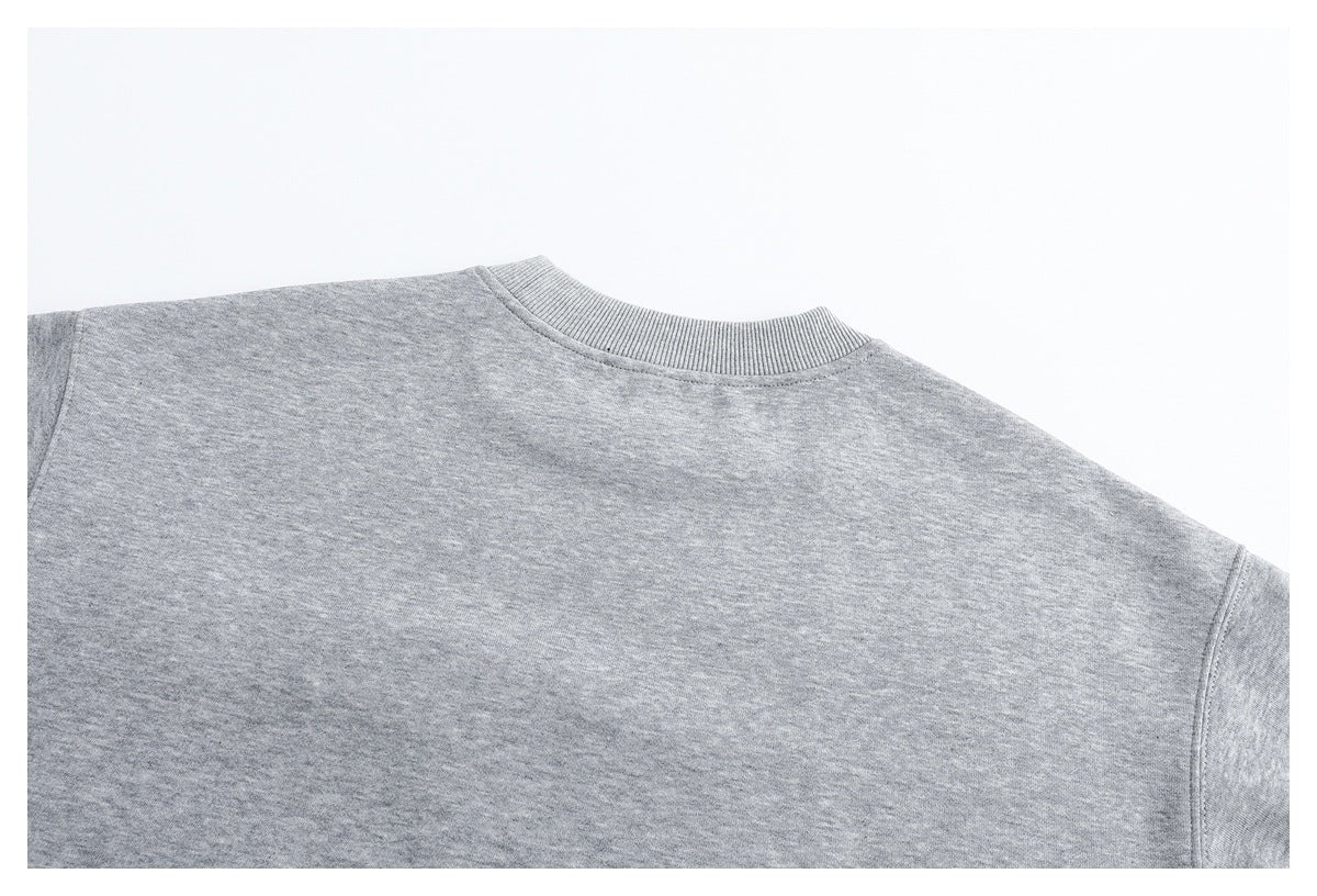 Close-up of the ribbed crew neckline and shoulder area of a heather gray sweatshirt.
