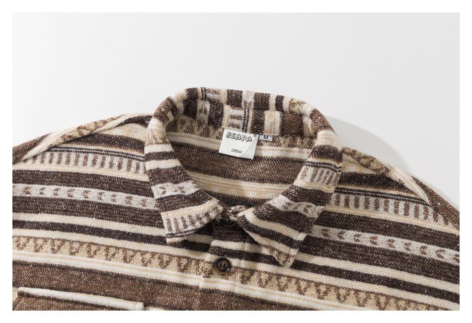 Cropped close-up of the collar and upper front of a brown, cream, and tan patterned shirt.