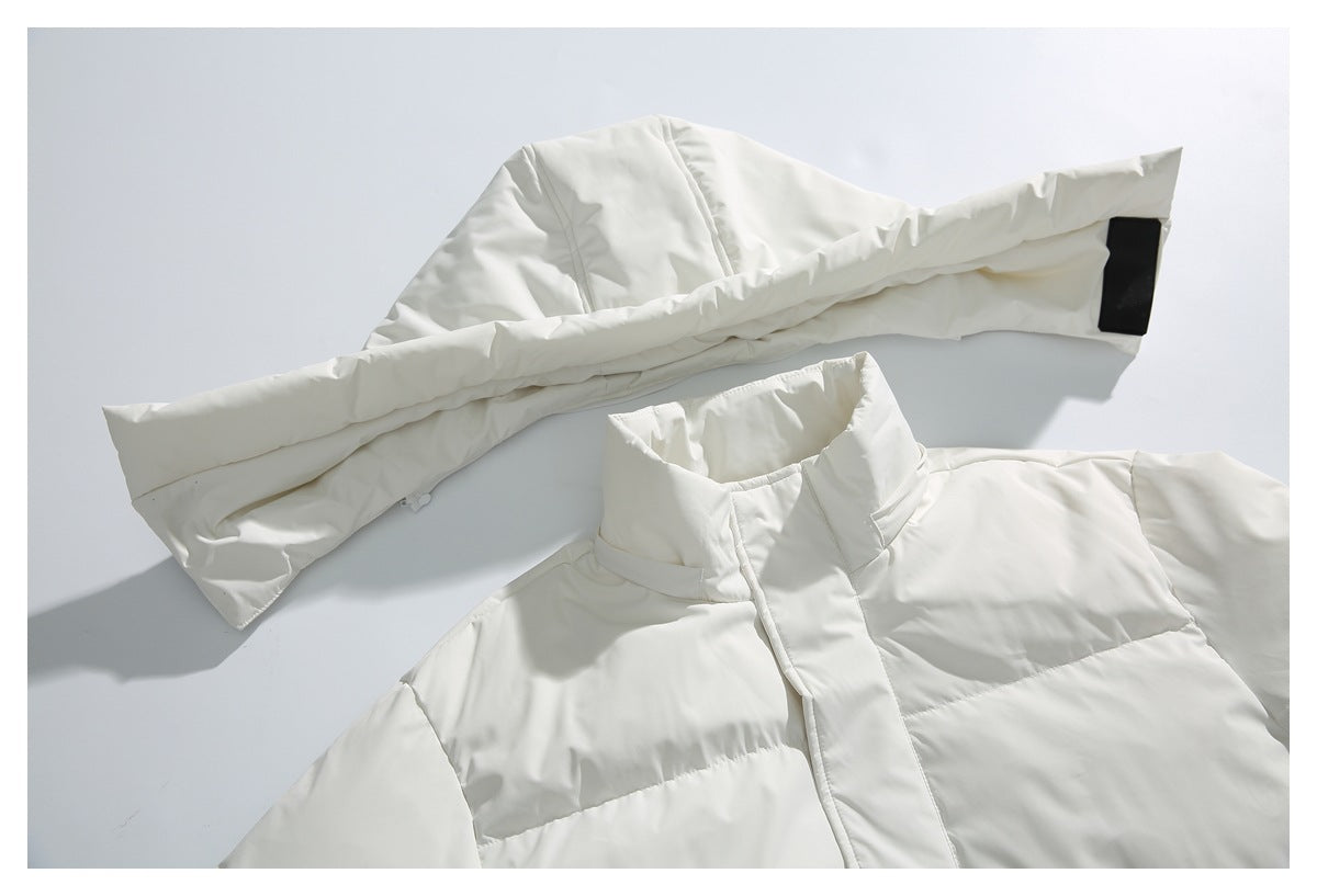 Ivory quilted jacket laid flat, showing its high collar, front placket and an extended sleeve.