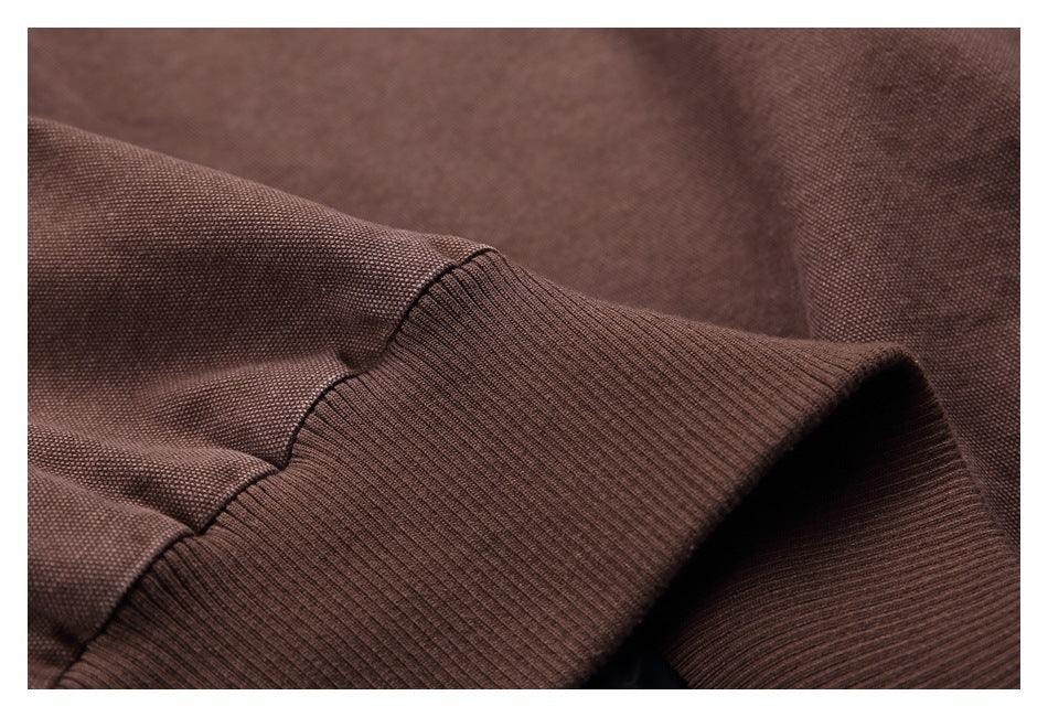 Close-up of a brown sleeve and wide ribbed cuff with visible stitching.