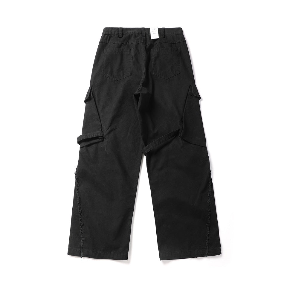 Black wide-leg cargo pants back view with two patch pockets, side cargo flaps, straps and frayed seams