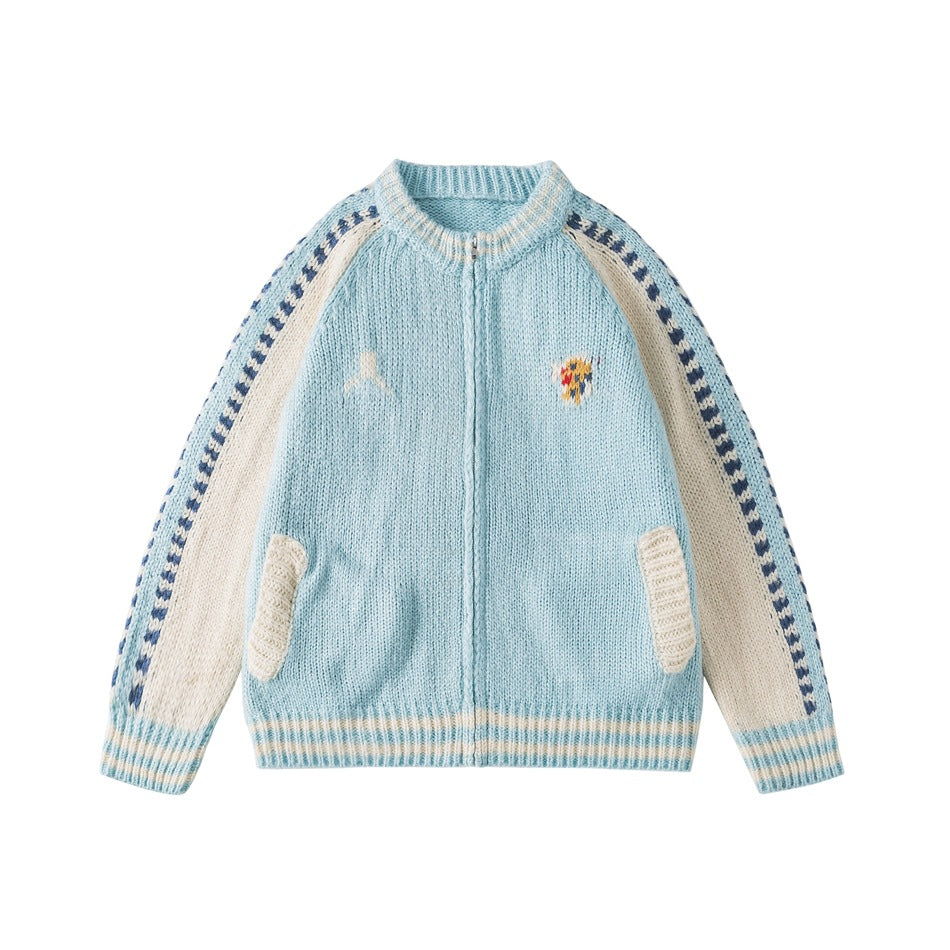 Light blue knit zip cardigan jacket with cream raglan sleeves, navy zigzag trim, striped cuffs and hem, front flat lay