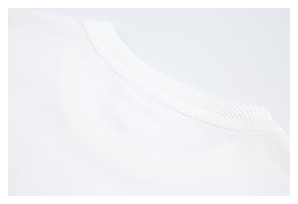 Close-up of the ribbed crew neckline and stitching on a white shirt.