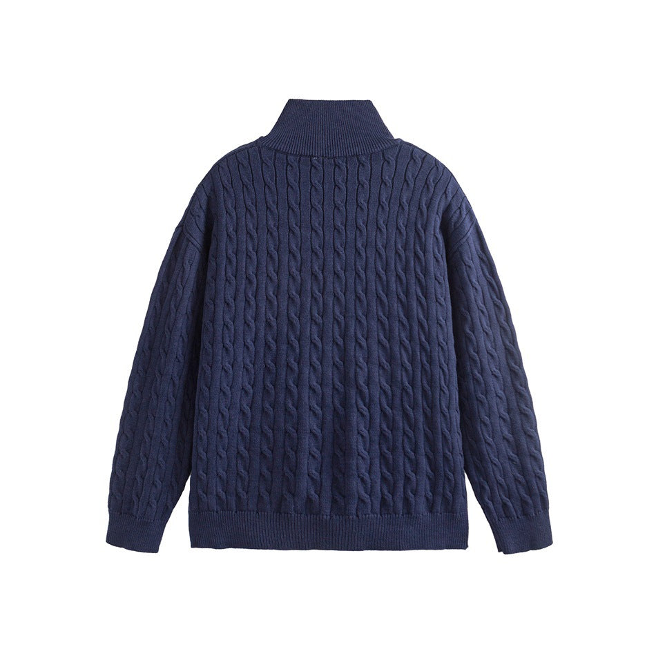 Back view of a navy cable-knit sweater with a high collar and ribbed cuffs and hem.