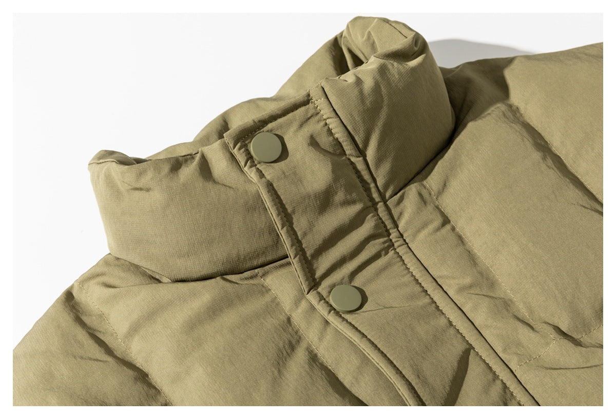 Close-up of an olive-tan padded jacket collar and snap-button storm flap.