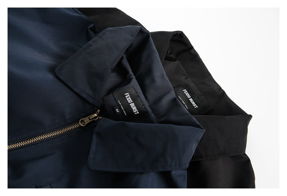 Close-up of navy and black jackets showing collars, zipper hardware, and sewn-in neck labels.