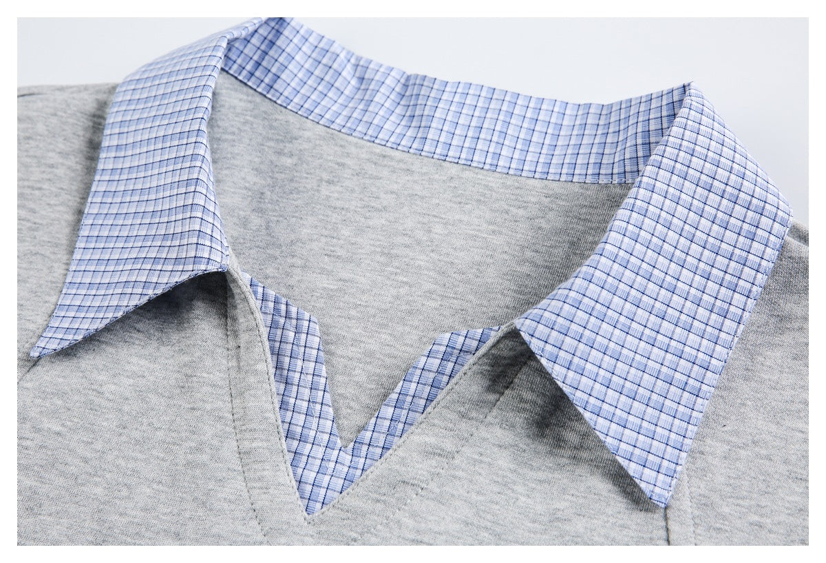 Close-up showing the blue checked collar, inner neckline, and V-shaped opening of the gray top.