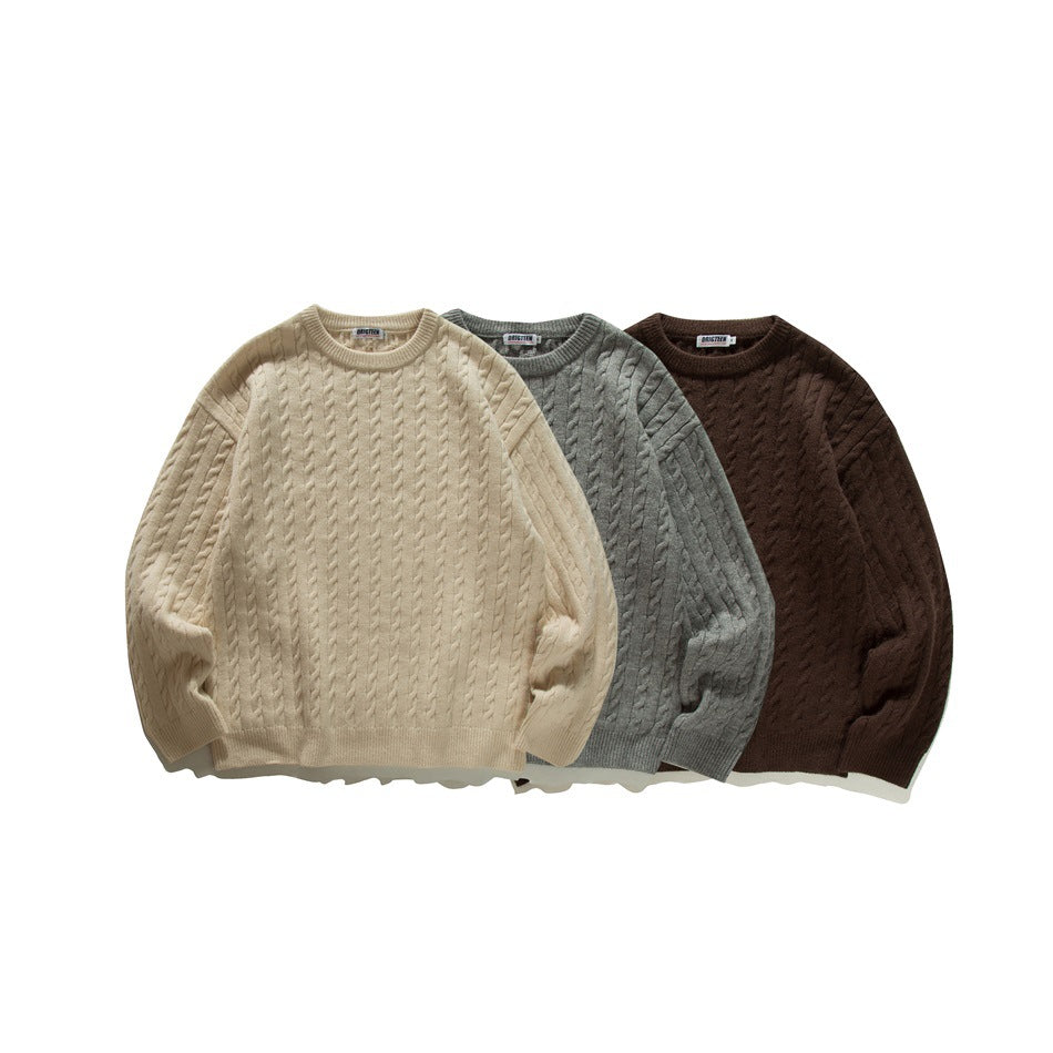 Three cable-knit crew-neck sweaters shown together in ivory, gray, and dark brown.