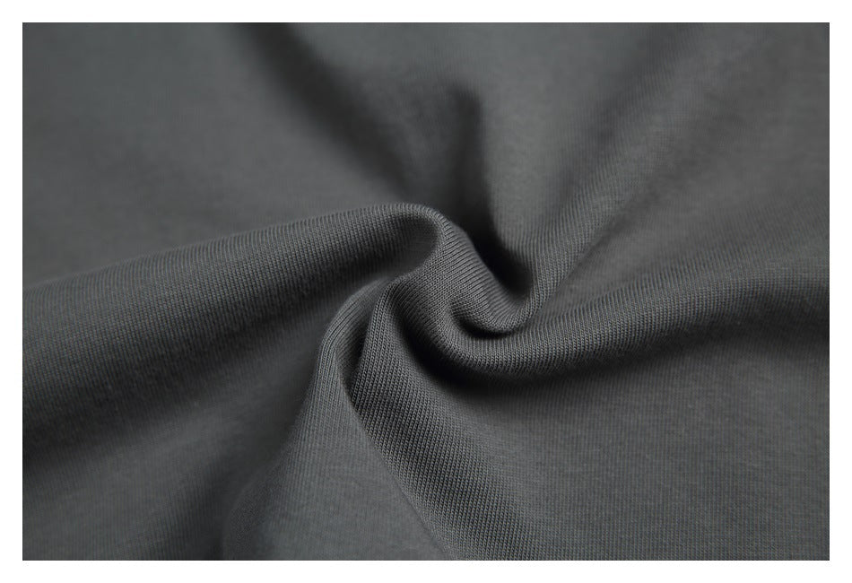 Close-up of charcoal fabric gathered to show its fine knit texture.