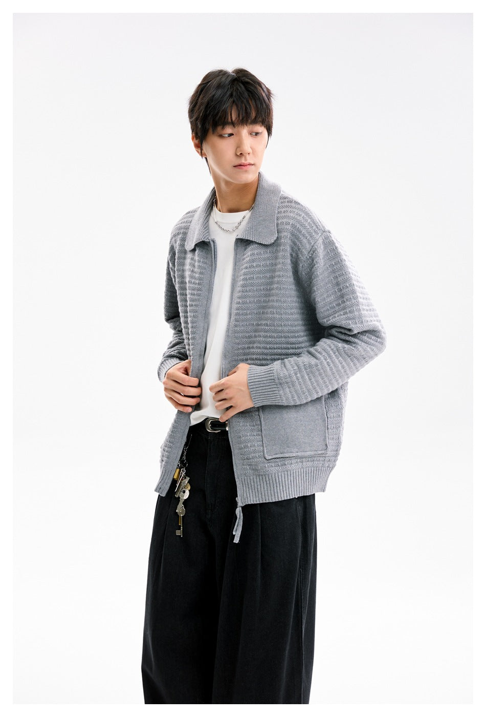 Model wearing a light gray textured knit jacket with a wide collar, front zip, ribbed cuffs and hem, and patch pockets.