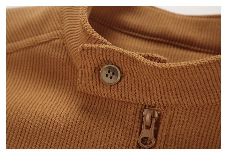 Close-up of the tan ribbed garment's collar, four-hole button, and zipper pull.