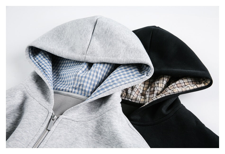 Gray and black zip-up hoodies shown with blue and beige plaid hood linings.