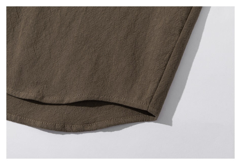 Close-up of the brown shirt's curved hem and side seam.