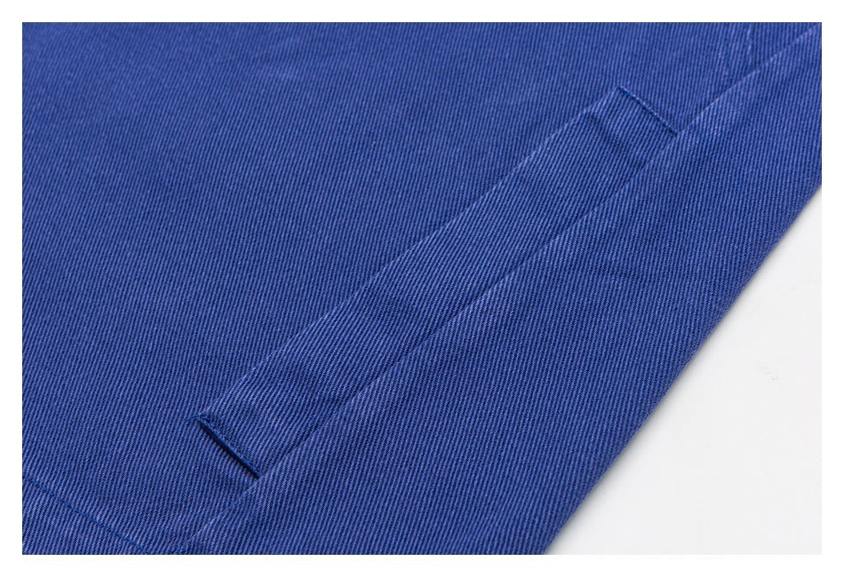Close-up of a narrow stitched blue fabric tab on the garment.