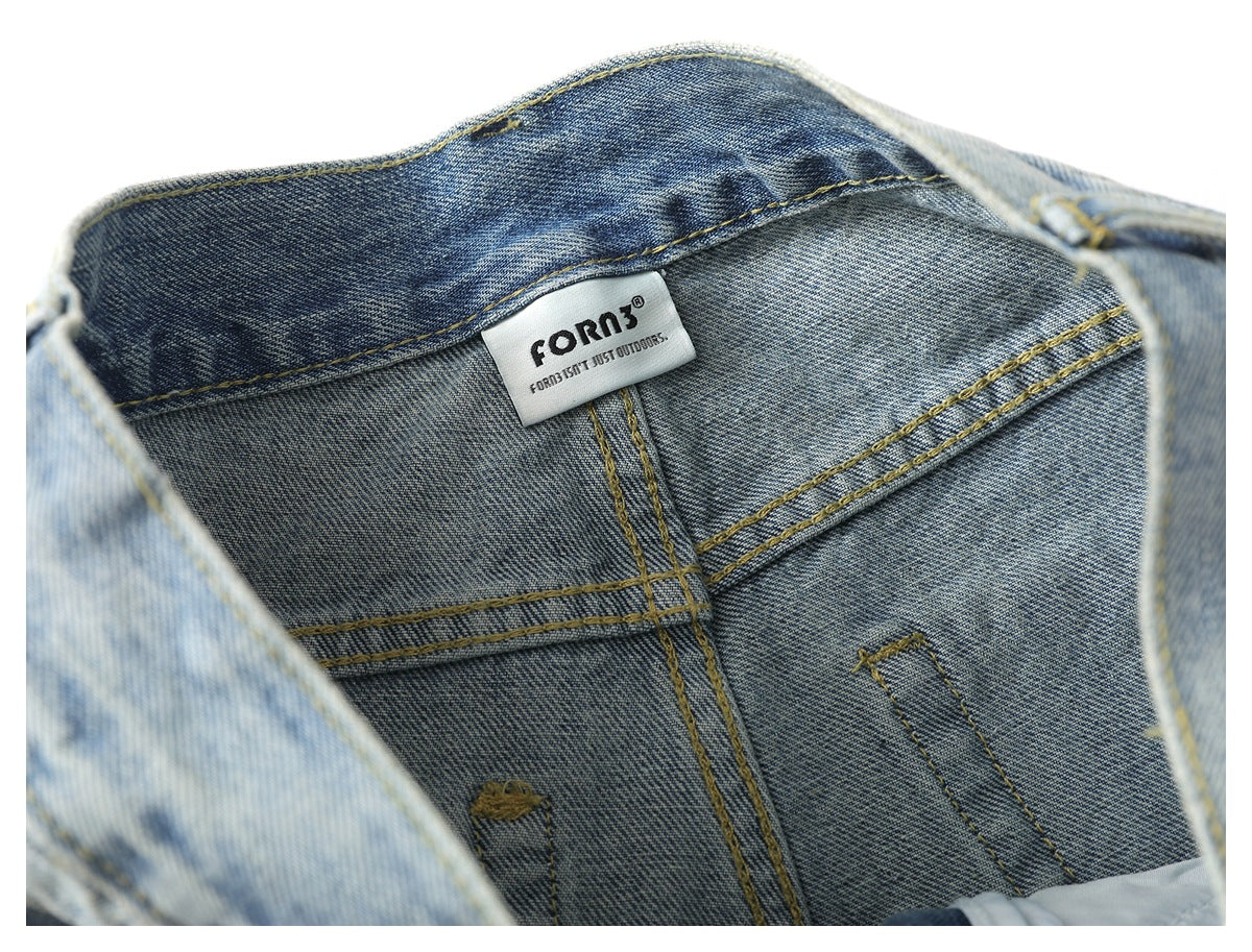 Inside waistband of faded blue jeans with a small white brand label and visible stitching.