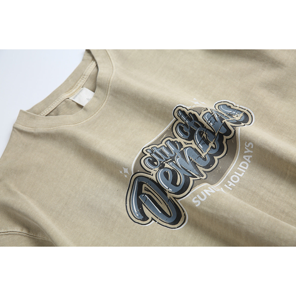Close-up of the beige T-shirt’s printed “City of Venice” chest graphic and crew neckline.