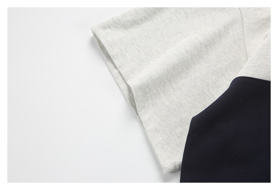 Close-up of a light heather-gray sleeve beside a dark navy section of the garment.