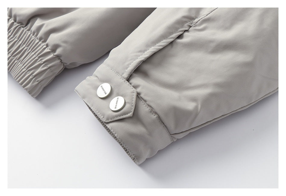 Close-up of a light gray garment cuff with gathered elastic and a tab fastened by two pale buttons.