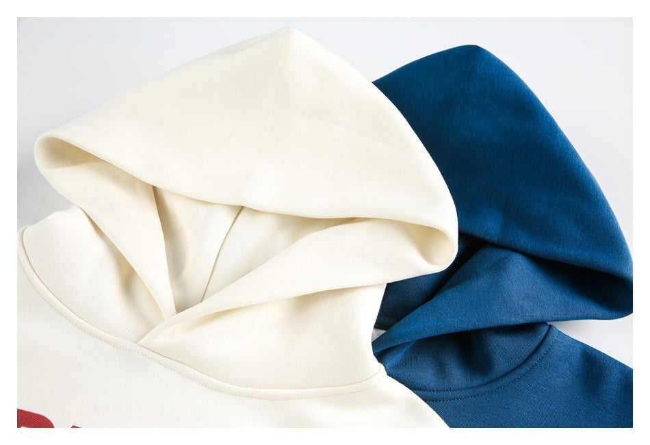 Close-up of the hoods and necklines of off-white and blue sweatshirts arranged together.