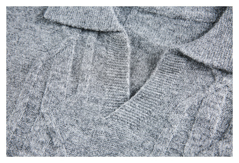 Close-up of the gray knit garment's V-shaped neckline and textured stitching.