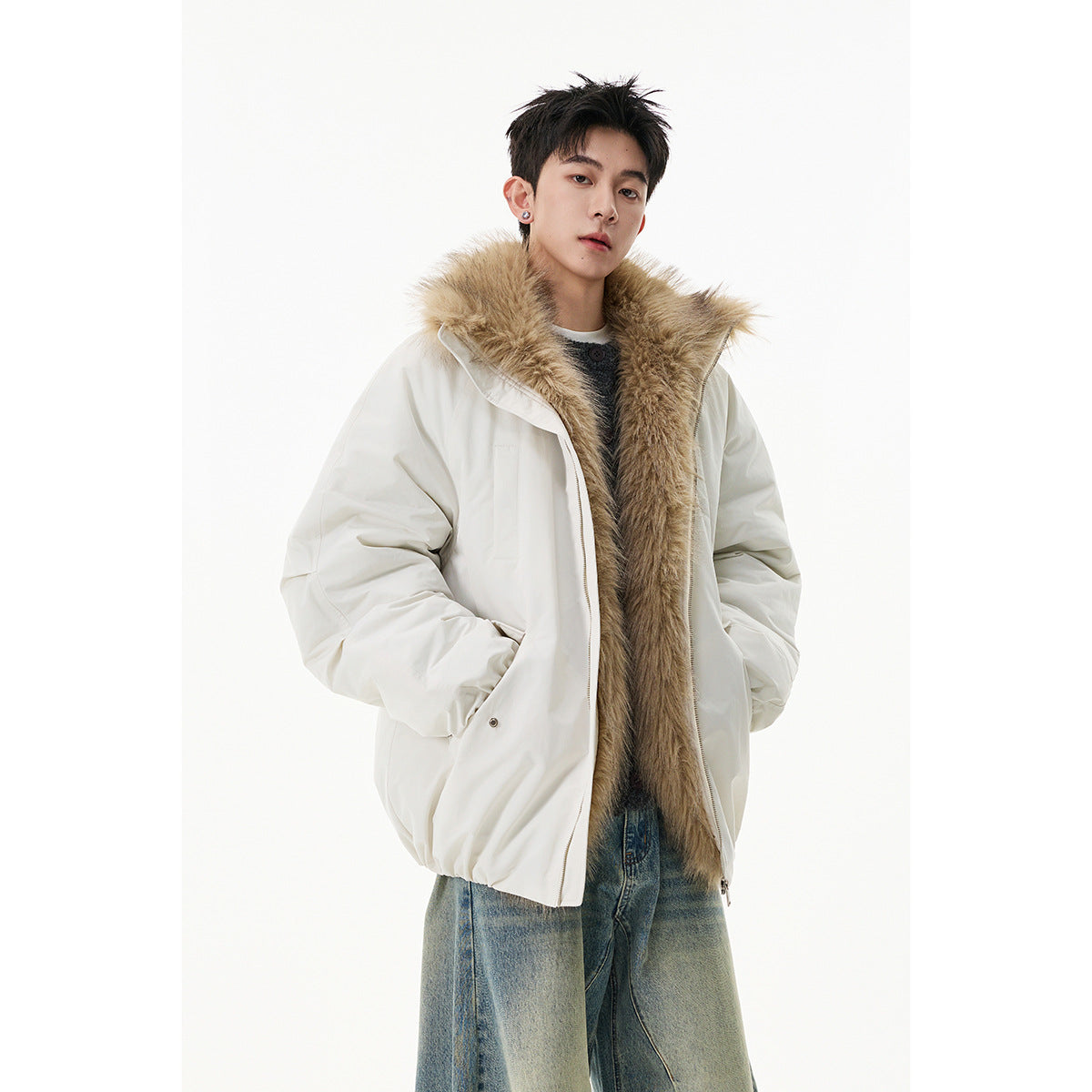Model wearing a white jacket with a long tan fur collar, paired with light-wash jeans.