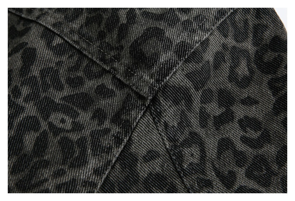 Close-up of seams and dark leopard pattern on charcoal fabric.