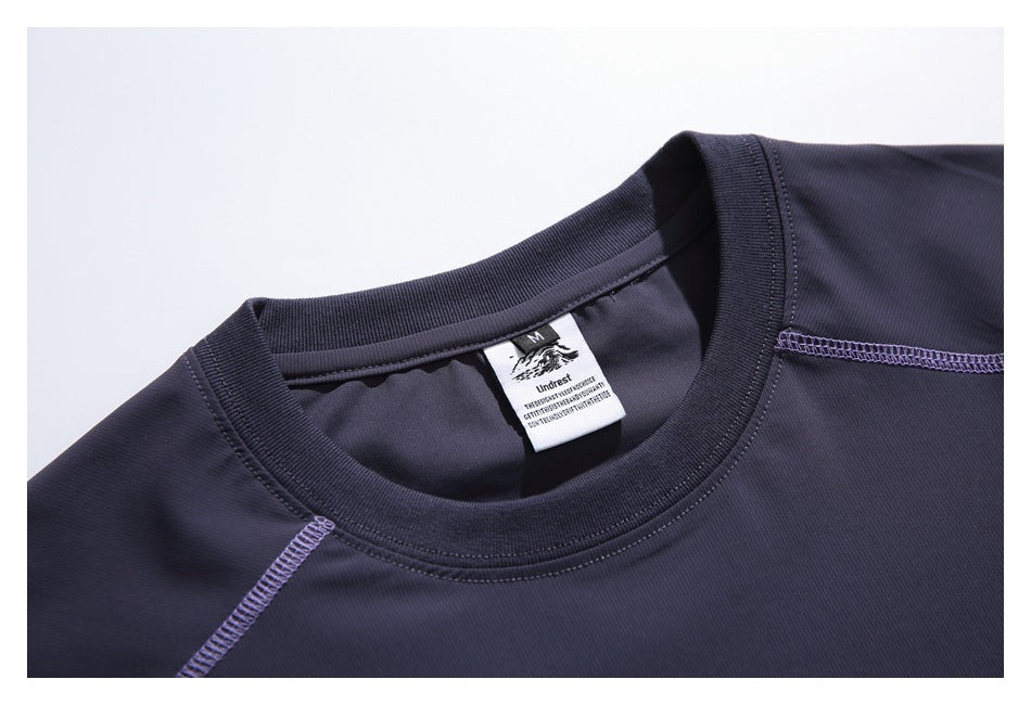 Close-up of a dark navy T-shirt neckline with a ribbed crew collar and visible inner label.