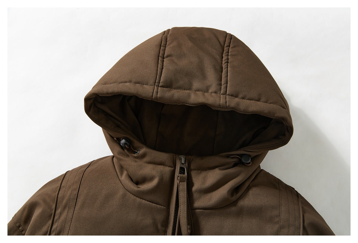 Close-up of the brown jacket's hood, drawcord toggles, and upper front zipper.
