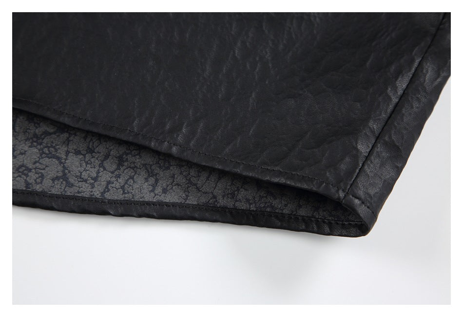 Close-up of the black shirt hem, showing the textured outer fabric and patterned inner facing.