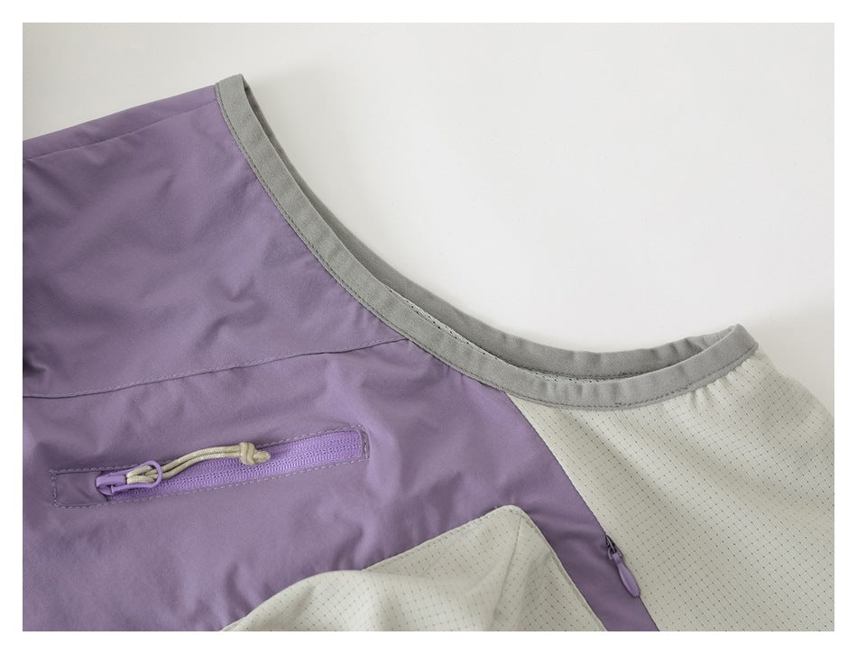 Close-up of a lavender jacket shoulder, cream perforated panel, gray collar trim, and zip pocket.