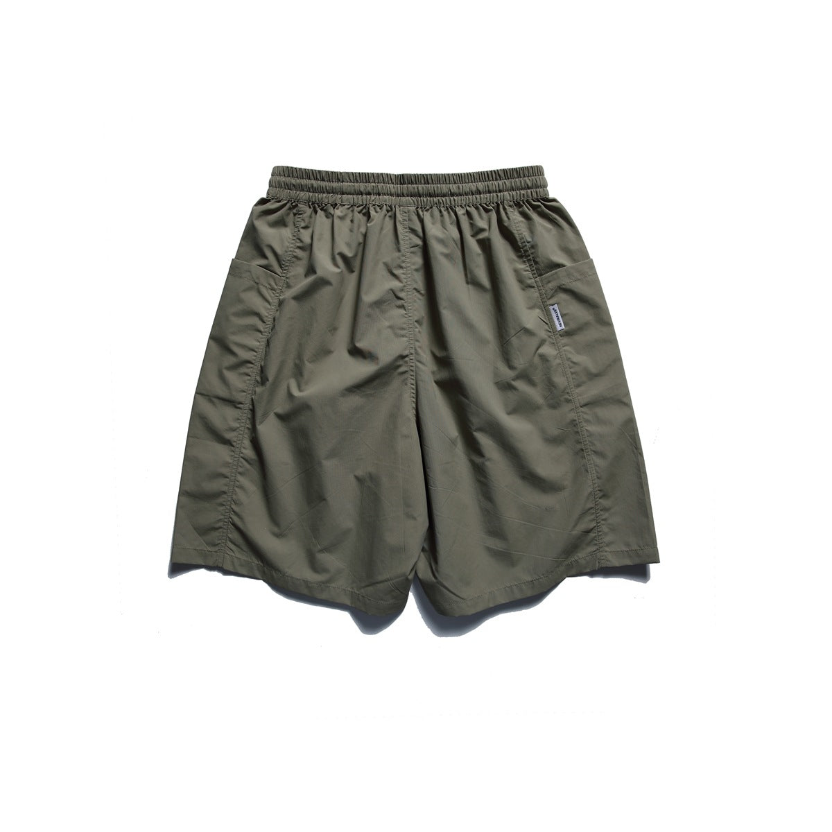 Back view of olive shorts with an elastic waistband and large side pockets.
