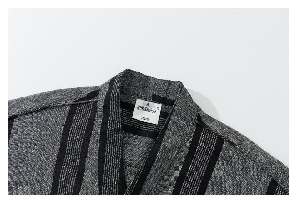 Close-up of a black and gray striped shirt collar with a sewn-in neck label.