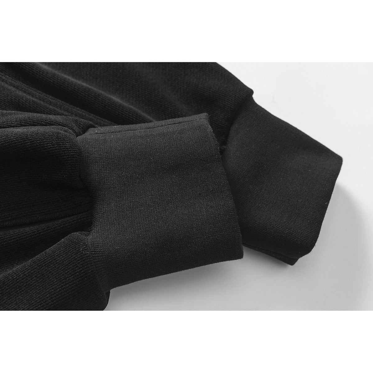 Close-up of a wide black ribbed cuff on the pants.