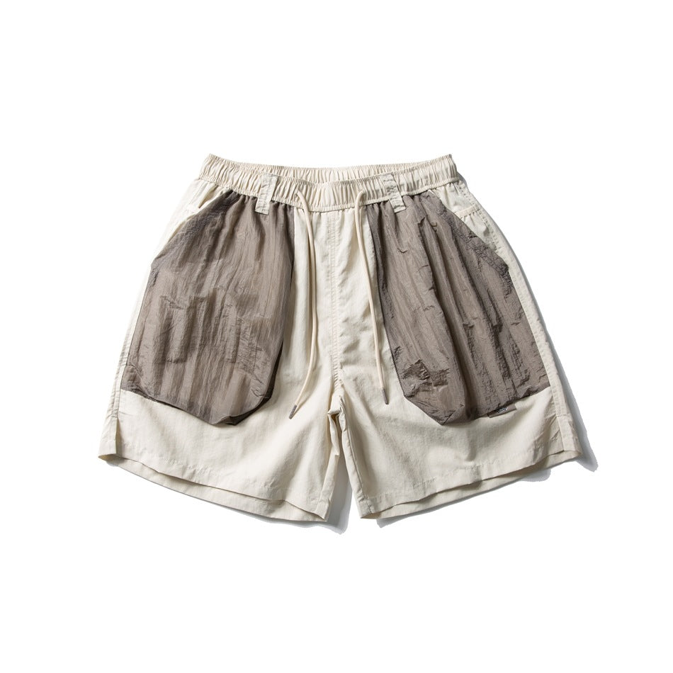 Cream drawstring shorts with large taupe-gray crinkled patch pockets, flat lay front view