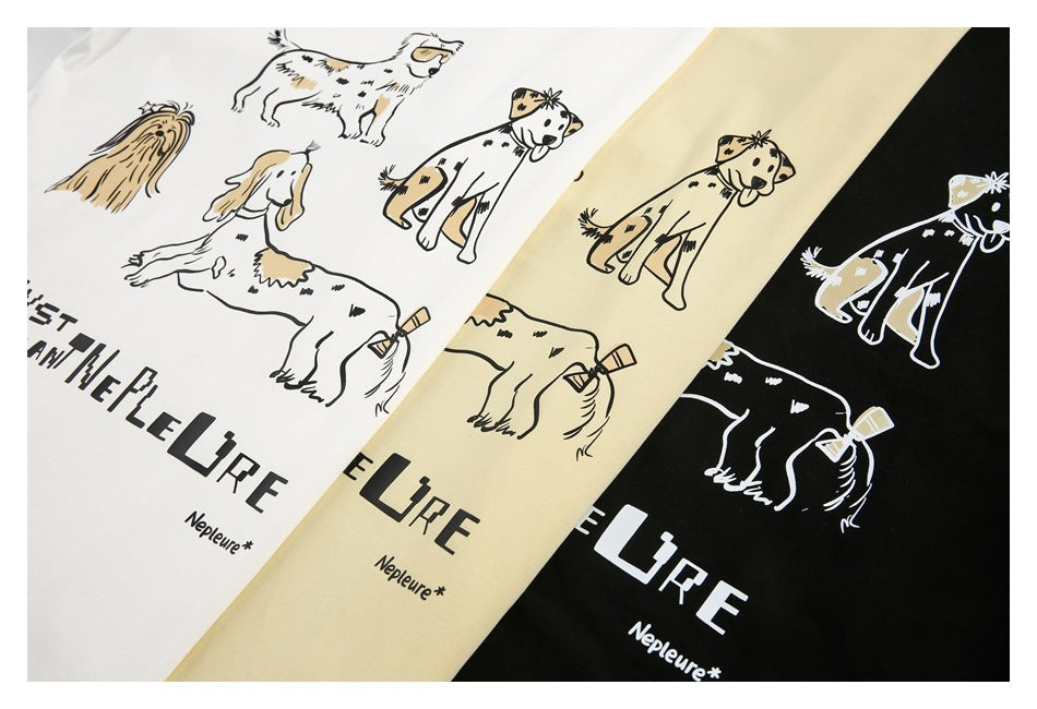White, pale yellow, and black shirts with illustrated dogs and English slogan prints, shown together.