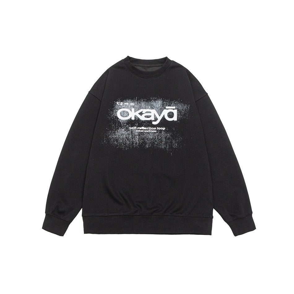 Black crew-neck sweatshirt flat lay with white distressed okaya chest graphic and ribbed cuffs and hem