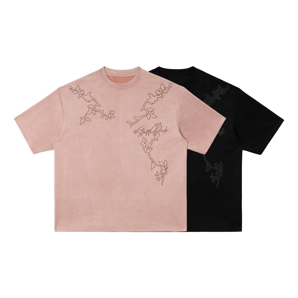 Two crew-neck short-sleeve T-shirts shown from the front in dusty pink and black, with outlined embroidered motifs.