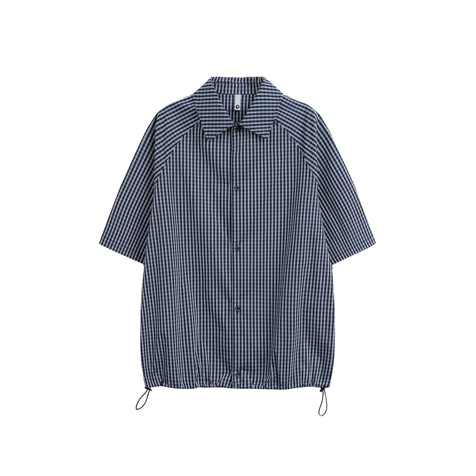 Navy check short-sleeve button-up shirt flat lay with pointed collar and drawcord hem with black toggles
