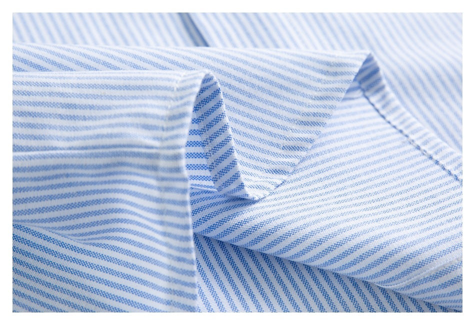 Close-up of the folded collar of a white shirt with fine blue stripes.