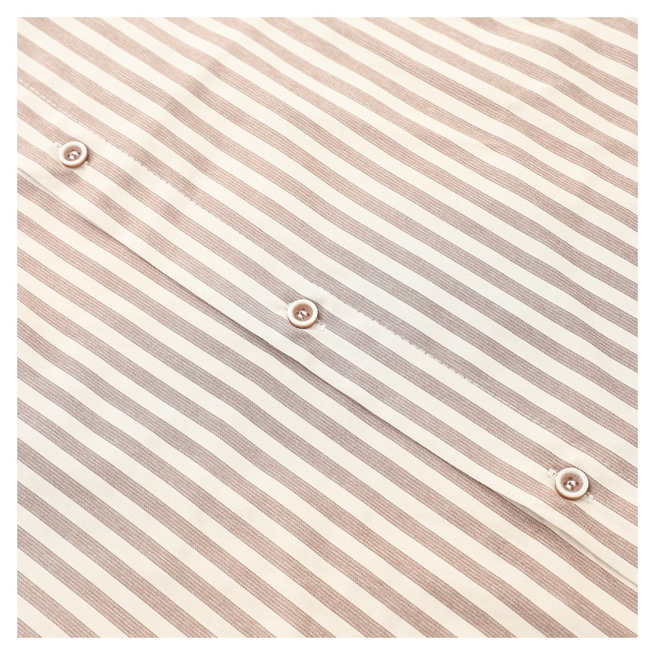 Close-up of three buttons along the placket of a cream shirt with narrow taupe stripes.