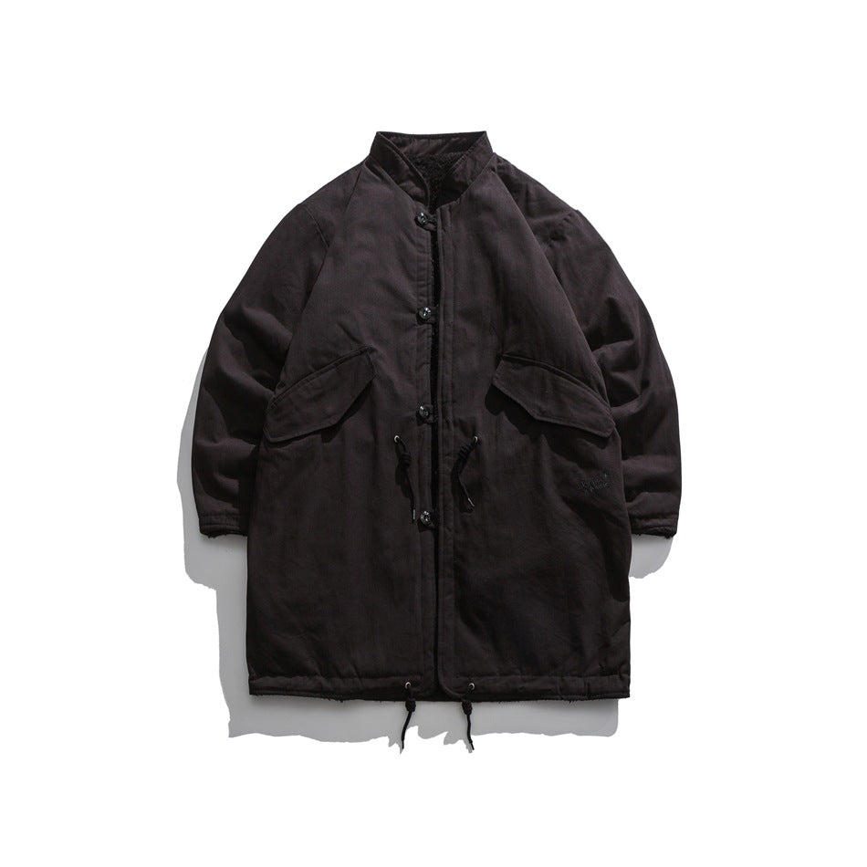 Front view of a dark brown-black long coat with a stand collar, button closures, flap pockets and waist drawcords.