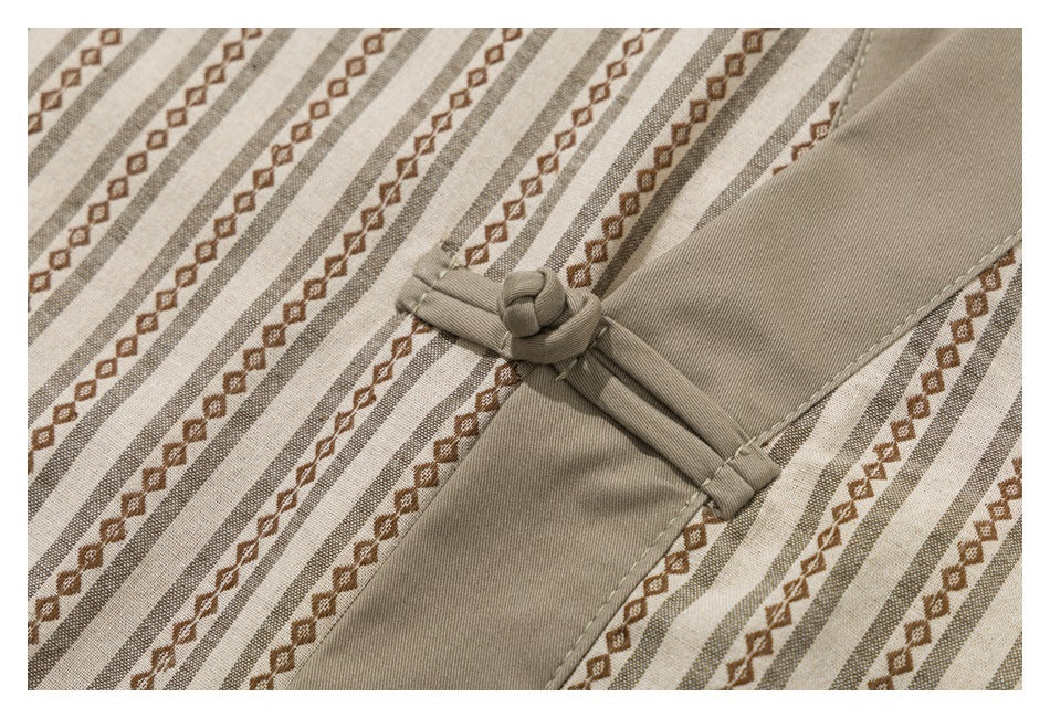 Close-up of a taupe fabric knot closure against beige fabric with brown geometric stripes.