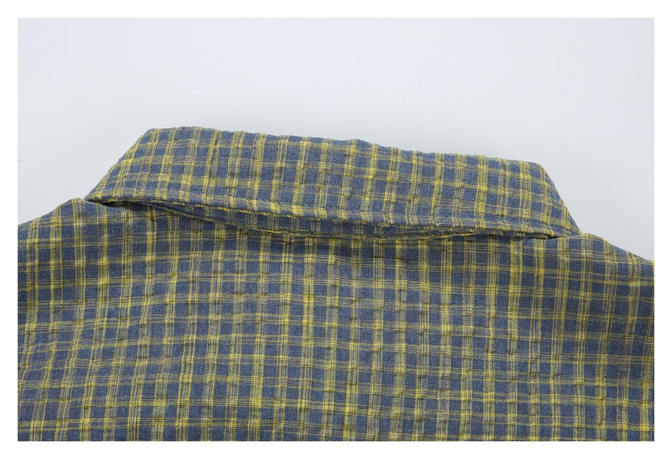 Close-up of the back collar and upper back of a blue-gray and mustard plaid shirt.