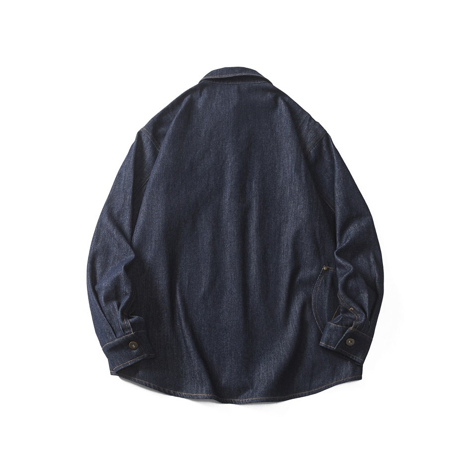 Back view of a dark indigo denim shirt laid flat, showing long sleeves, button cuffs and a curved hem.