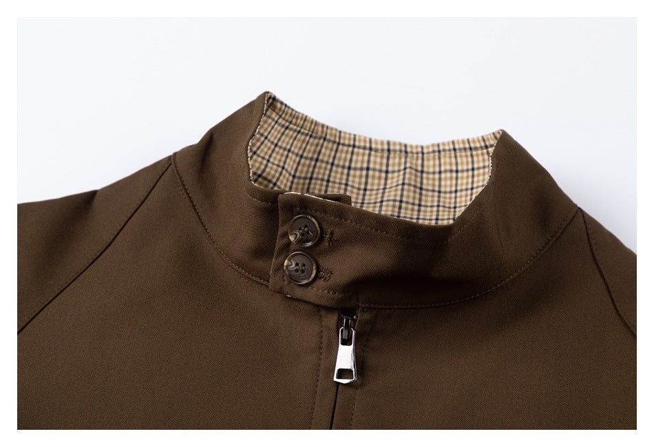 Close-up of the jacket's stand collar, two-button closure, zipper, and beige checked lining.