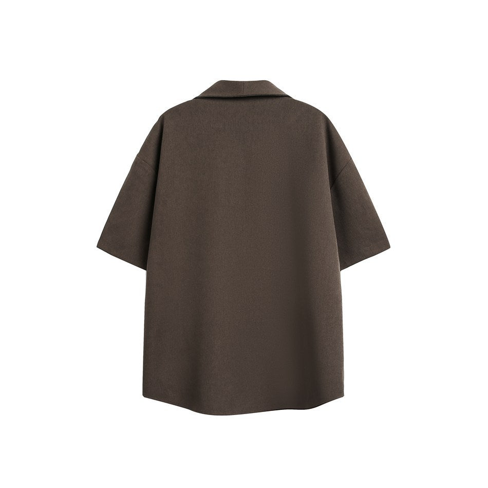 Back view of a plain brown oversized short-sleeve collared garment laid flat on a white background.