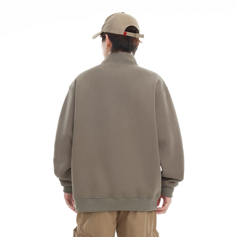 Back view of a taupe pullover worn with tan trousers.